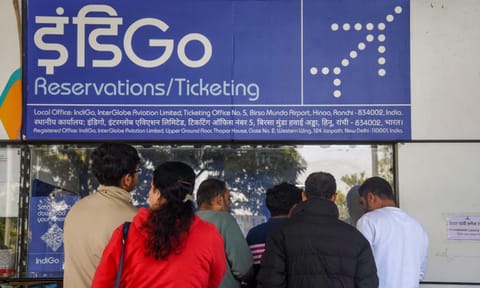Passengers enquire at an IndiGo airlines counter amid flight disruptions, at Birsa Munda Airport, in Ranchi