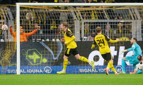 Borussia's Julian Brandt celebrates with teammates after scoring the opening goal during Germany Bundesliga soccer match between Borussia Dortmund and TSG 1899 Hoffenheim, in Dortmund, Germany, Sunday, Dec. 7, 2025 (AP) 