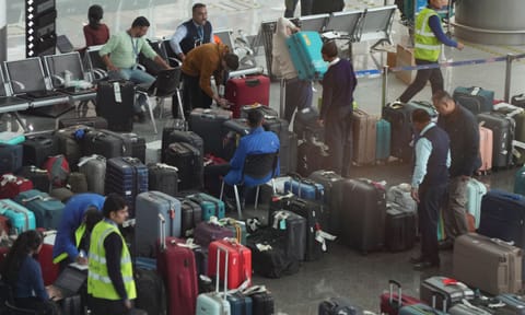 Passengers try to find their luggage amongst the piled-up lot at the Indira Gandhi International Airport amid IndiGo flight disruptions, in New Delhi, Monday, Dec. 8, 2025. (PTI) 