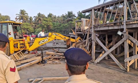An excavator demolishes wooden structures at Romeo Lane on Anjuna beach after a fire at the adjacent Birch by Romeo Lane nightclub killed 25 people, as the state administration begins pulling down the tourism property, in Goa (PTI) 