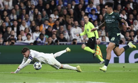 Goalscorer Nico O'Reilly (R) fends off Federico Valverde during match
