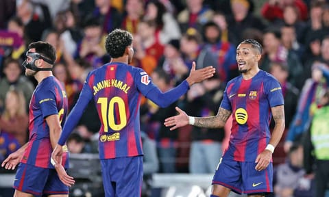 Raphinha celebrates with Lamine Yamal after scoring