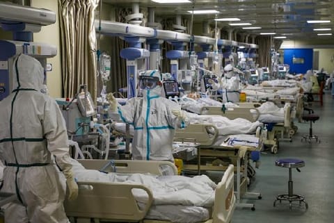 Medical workers in protective suits attend to coronavirus patients at the intensive care unit (ICU) of a designated hospital in Wuhan, Hubei province, China