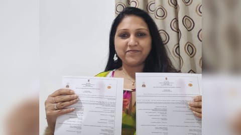 Malini with death certificates of her parents.