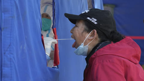 A resident gets swabbed during mass Covid-19 test