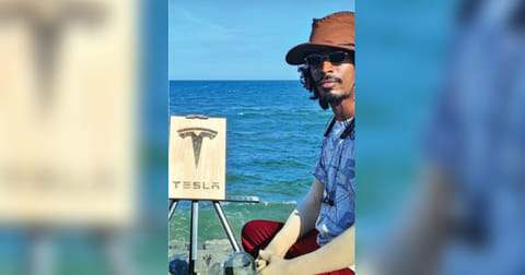 R Vignesh with the Tesla logo