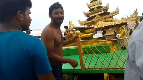 People dragging the chariot out to the shore
