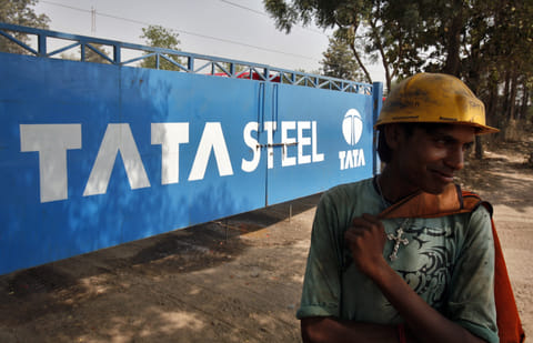 A labourer stands outside a Tata Steel stockyard