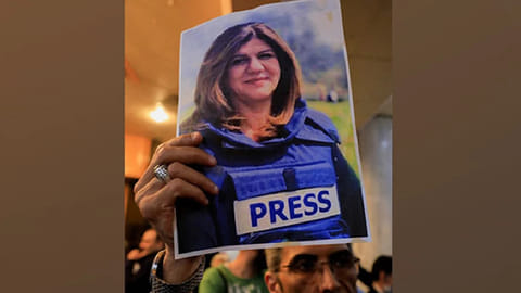A man holds picture of late Al Jazeera journalist Shireen Abu Akleh