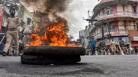Police personnel patrol amid protests against Centre's 'Agnipath' scheme, in Patna