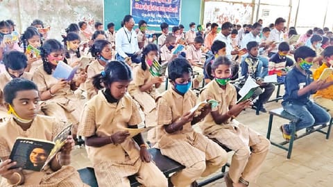 Thanjavur CEO Sivakumar reading along with Thanjavur Corporation HSS students on Monday.