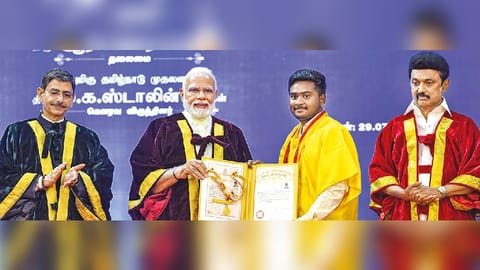 PM Modi awards a degree to a student during the 42nd Convocation of Anna University. CM Stalin and Governor Ravi are also seen