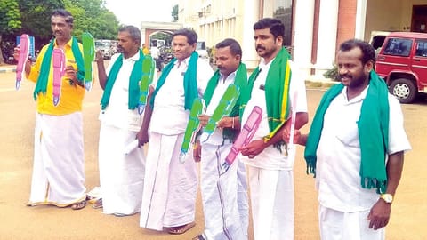 Farmers protest holding pen models objecting to a memorial to M Karunanidhi while seeking more godowns
