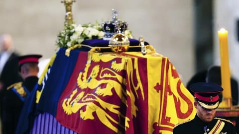 (L-R) Prince William, the prince of Wales and Prince Harry participate in the vigil of the Queen's grandchildren around the coffin, as it lies in state on the catafalque in Westminster Hall, at the Palace of Westminster, London.