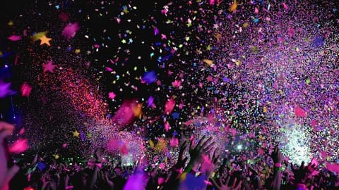 A burst of colour and confetti fills the air as the crowd celebrates in a moment of pure energy and joy.