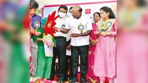 Health Minister distributing deworming pills at the camp