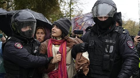 Police officers detain a demonstrator during a protest against a partial mobilization in Moscow, Russia, Saturday.