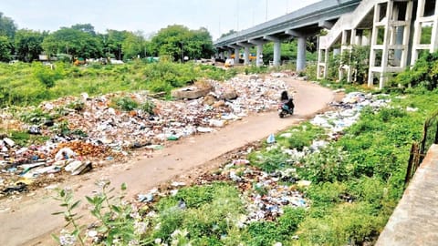 Garbage piling up on both sides of the road connecting Pallavaram Railway Station with GST Road