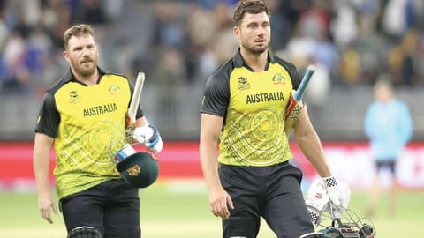 Australia?s Aaron Finch (left) and Marcus Stoinis walk off the field after their win.