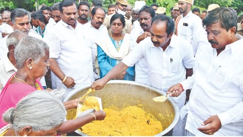 Minister Siva V Meyyanathan distributing food at a flood hit area in Mayiladuthurai on Thursday