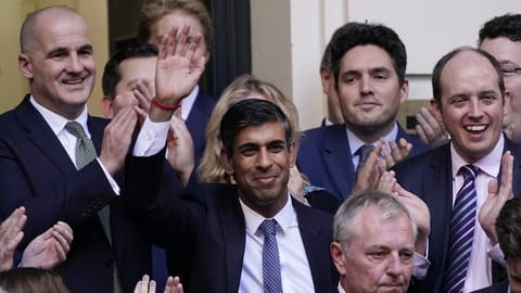 Rishi Sunak, centre, waves after winning the Conservative Party leadership contest at the Conservative party Headquarters in London.