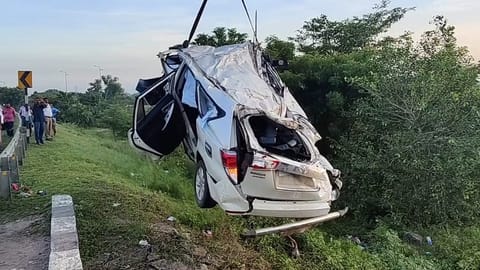 The damaged car being recovered from the gorge.