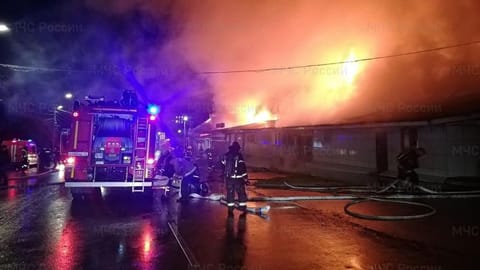 Firefighters try to extinguish a fire at a cafe