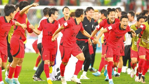 South Korea?s players celebrate after qualifying for knockout stages