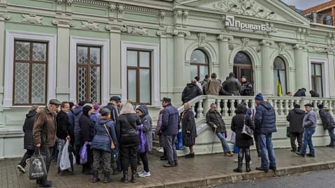 Residents queue at a bank branch in Kherson, southern Ukraine.