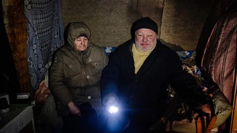 A Ukrainian couple sit in a basement where they shelter and live in Seversk, Donetsk.