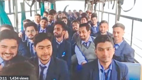 group of college students in uniform chanting slogans