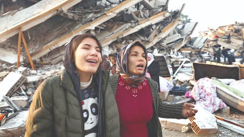 Women sob near rubble as search for survivors continue in Hatay, Turkey on Tuesday
