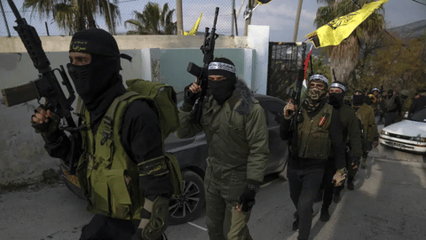 Palestinian militants take part in a military parade