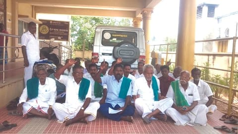 Farmers staging a sit-in at Nemili taluk office against revenue department officials in Ranipet on Thursday