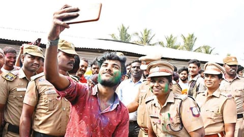 Perambalur SP C Shyamaladevi and cops celebrate Holi with migrant workers on Thursday.