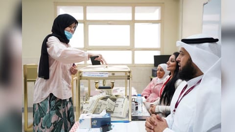 A woman votes during parliamentary elections at a polling station in Kuwait City, Kuwait September 29, 2022
