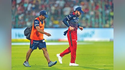 Virat Kohli limps off the field.