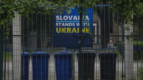 A billboard showing support for Ukraine on display in between fences at the Slovakia Embassy in Beijing on May 17, 2023.