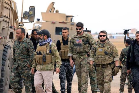 Syrian Democratic Forces and U.S. troops are seen during a patrol near Turkish border in Hasakah