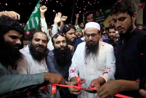 Hafiz Muhammad Saeed cuts a ribbon to inaugurates an election office