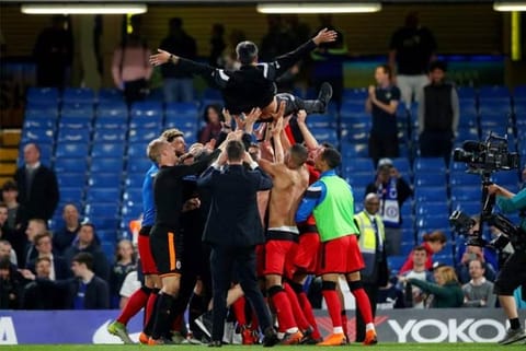 Huddersfield Town manager David Wagner celebrates staying in the premier league with their players