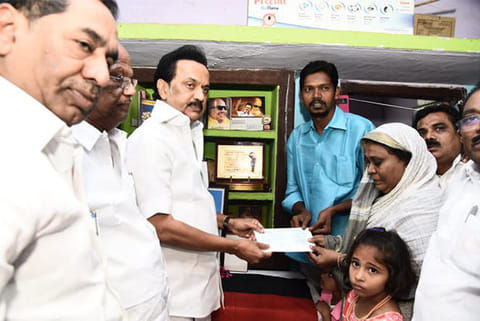 DMK chief MK Stalin providing Rs 5 lakh to kin of deceased partyman Saleem in Madurai on Sunday