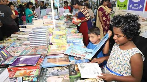 Children browse through books at the fair