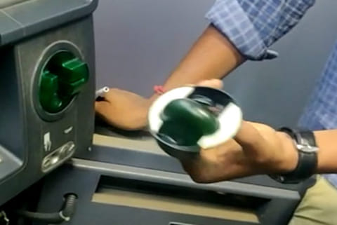 A skimmer device designed to look like the card insertion slot placed at an ATM