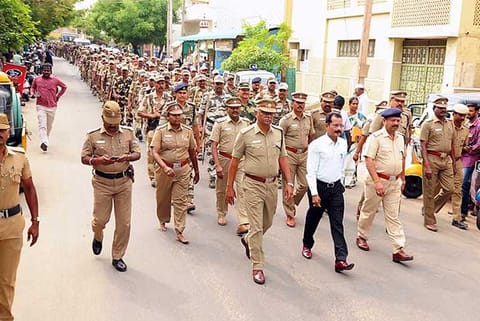 Karur SP T K Rajasekaran and district collector T Anbalagan lead a flag march in Aravakurichi on Wednesday