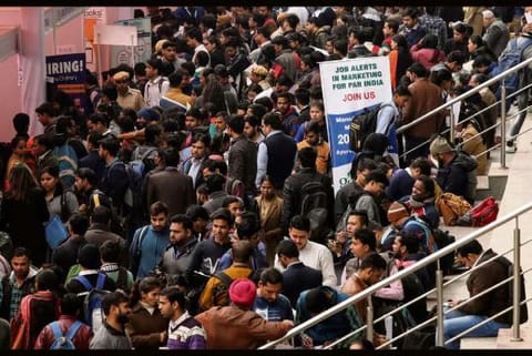 Job seekers attend a job fair - Source: Reuters
