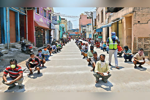 Migrant workers queue up for food at Ambattur