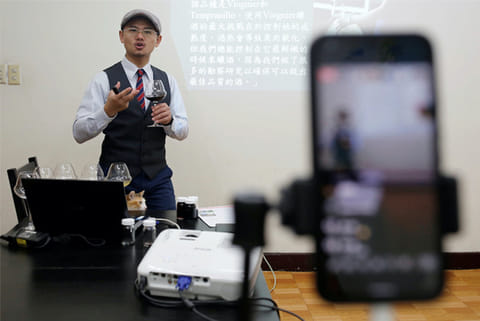 Peter Petrus, 37, a Taiwanese sommelier, conducts an online wine tasting class from studio (Reuters)