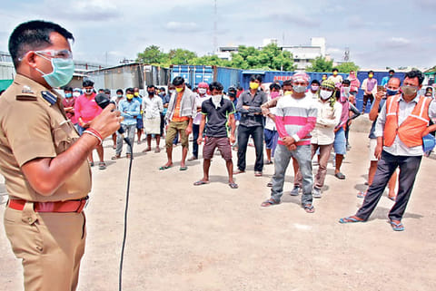 Vellore SP Pravesh Kumar addressing migrant workers in Vellore on Monday