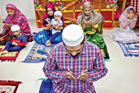 A man during Ramzan namaz at his house
